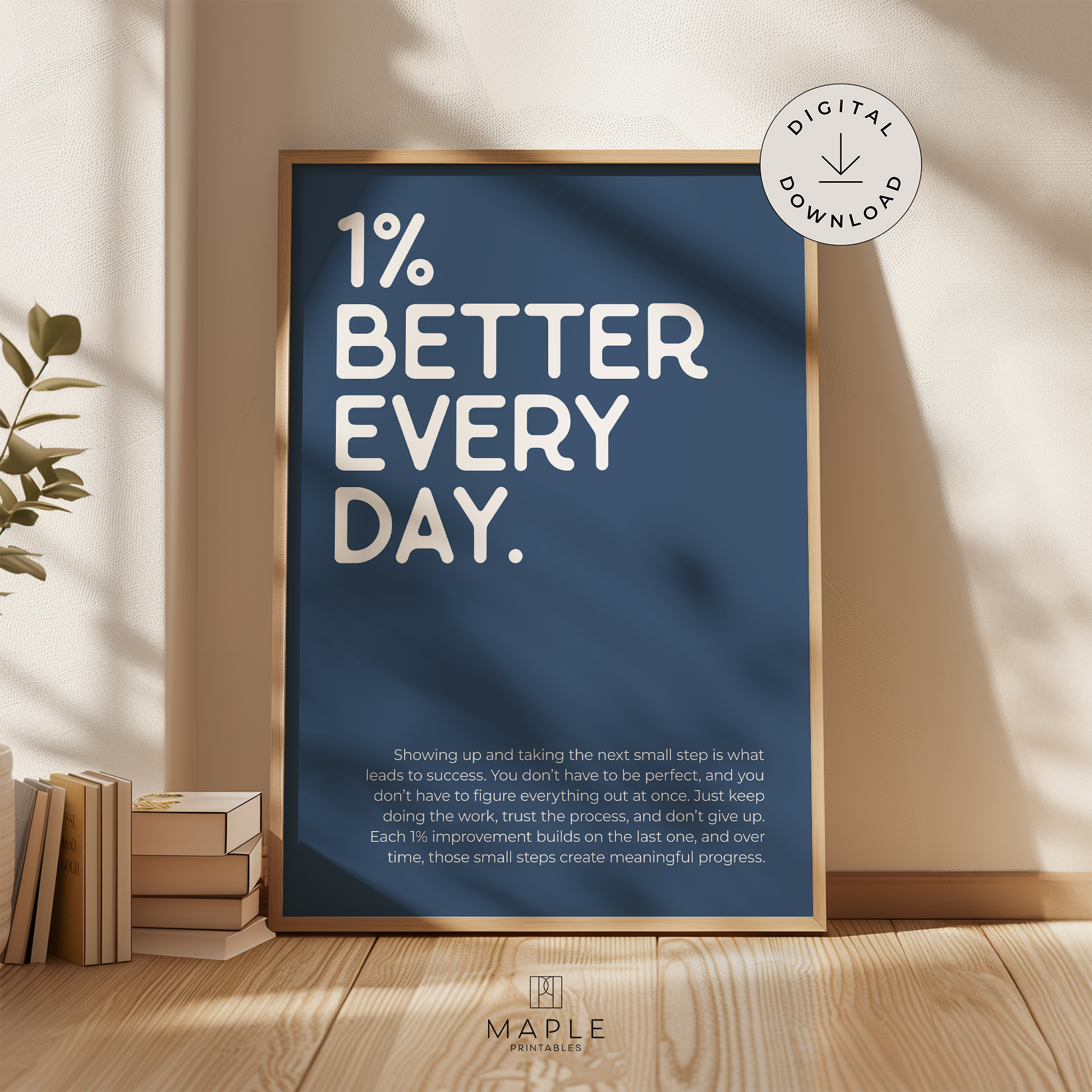 Motivational poster with quote '1% Better Every Day' in white letters on a navy blue background. Minimalist style. Shown in a wood frame leaning on a wall.