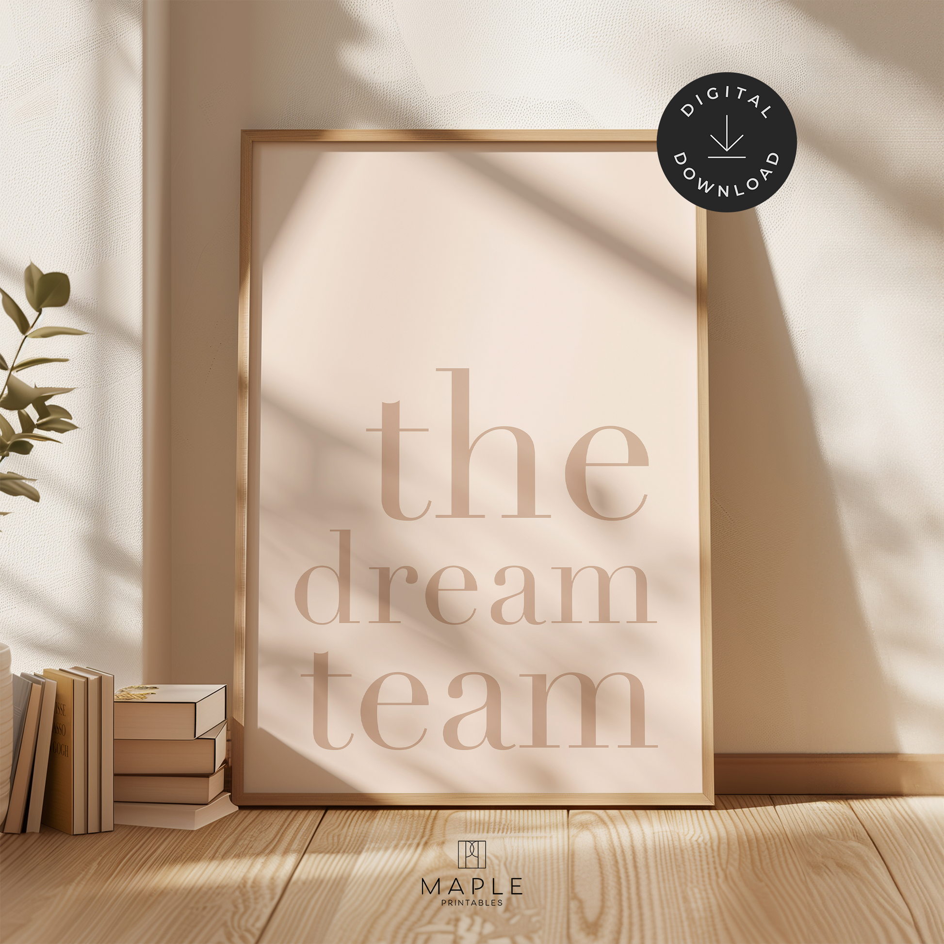 Teamwork poster with quote 'the dream team' in large light brown letters on a soft beige background. Minimalist style. Shown in a wood frame leaning on a wall.