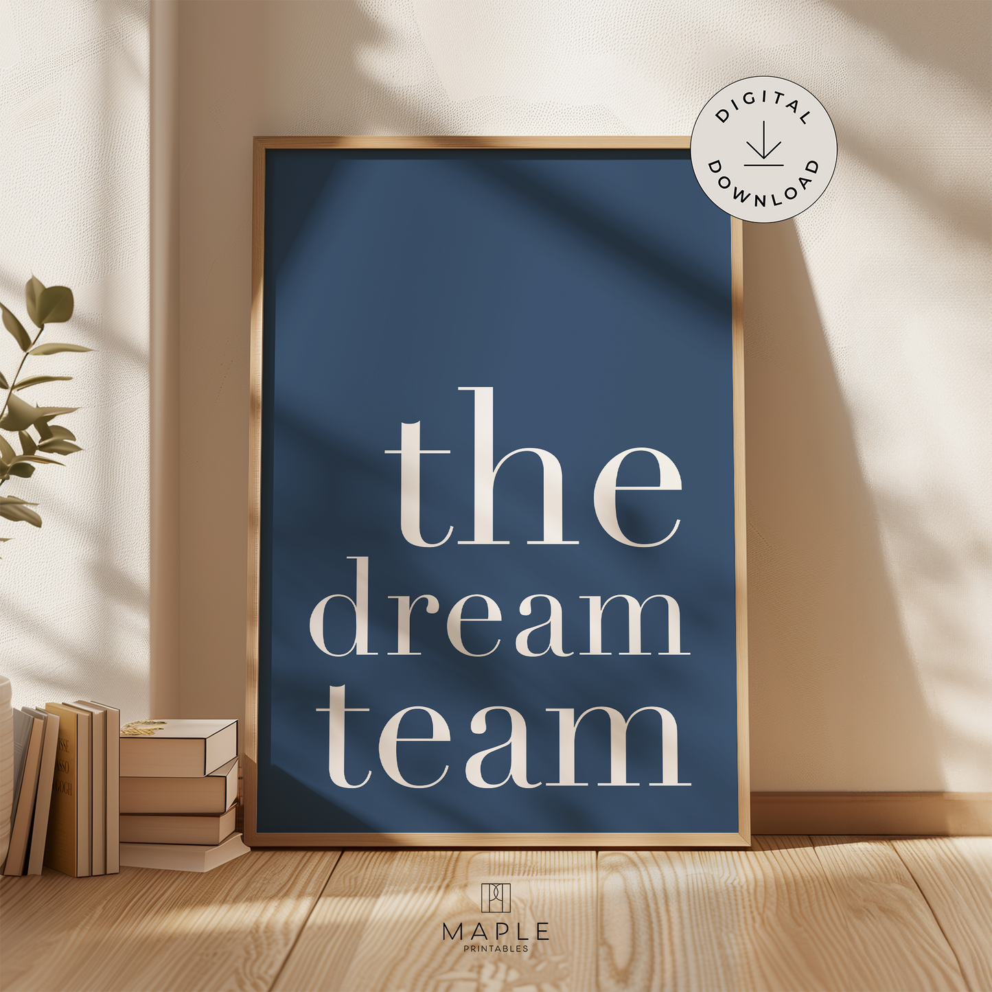 Teamwork poster with quote 'the dream team' in large white letters on a navy blue background. Minimalist style. Shown in a wood frame leaning on a wall.