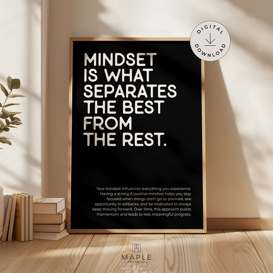 This image shows a framed motivational poster with the large words “Mindset is what separates the best from the rest” in the top left corner, and a longer paragraph at the bottom in a smaller font size. The print features bold white lettering on a black background and is displayed in a light wood frame. It’s styled in a warm, neutral space with soft sunlight and a plant nearby. A small circle in the corner says “Digital Download.”