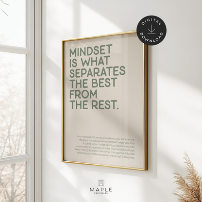 This image shows a hanging framed motivational poster with the large words “Mindset is what separates the best from the rest” in the top left corner, and a longer paragraph at the bottom in a smaller font size. The print features sage green lettering on a beige background and is displayed in a gold frame. It’s styled in a bright space with a window and a plant nearby. A small circle in the corner says “Digital Download.”