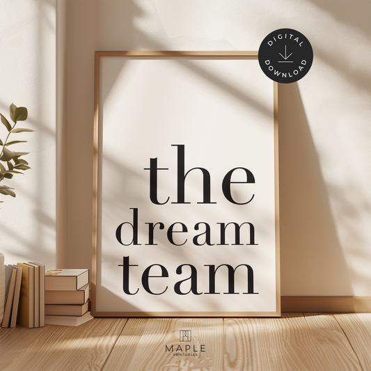 Teamwork poster with quote 'the dream team' in large black letters on a white background. Minimalist style. Shown in a wood frame leaning on a wall.