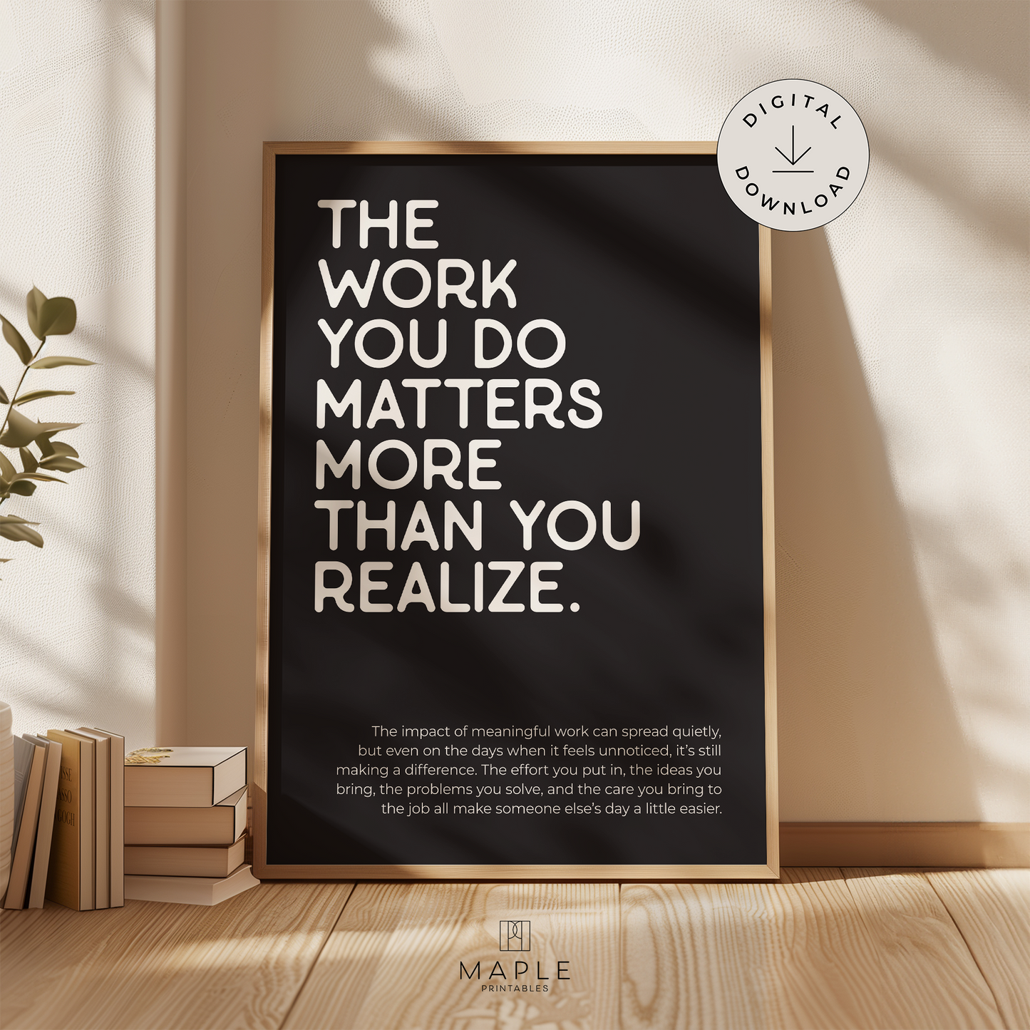 Motivational poster with quote 'The work you do matters more than you realize' in white letters on a black background. Minimalist design style. Shown in a wood frame leaning on a wall.