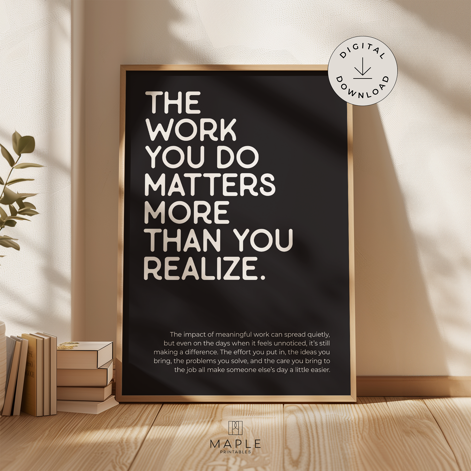 Motivational poster with quote 'The work you do matters more than you realize' in white letters on a black background. Minimalist design style. Shown in a wood frame leaning on a wall.