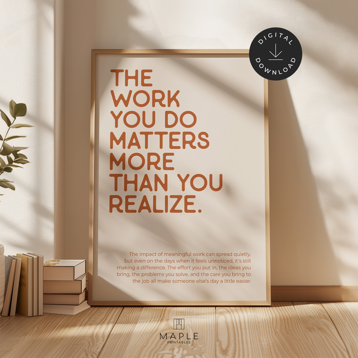 Motivational poster with quote 'The work you do matters more than you realize' in orange letters on a beige background. Shown in a wood frame leaning on a wall.