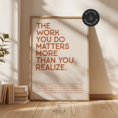 Motivational poster with quote 'The work you do matters more than you realize' in orange letters on a beige background. Shown in a wood frame leaning on a wall.